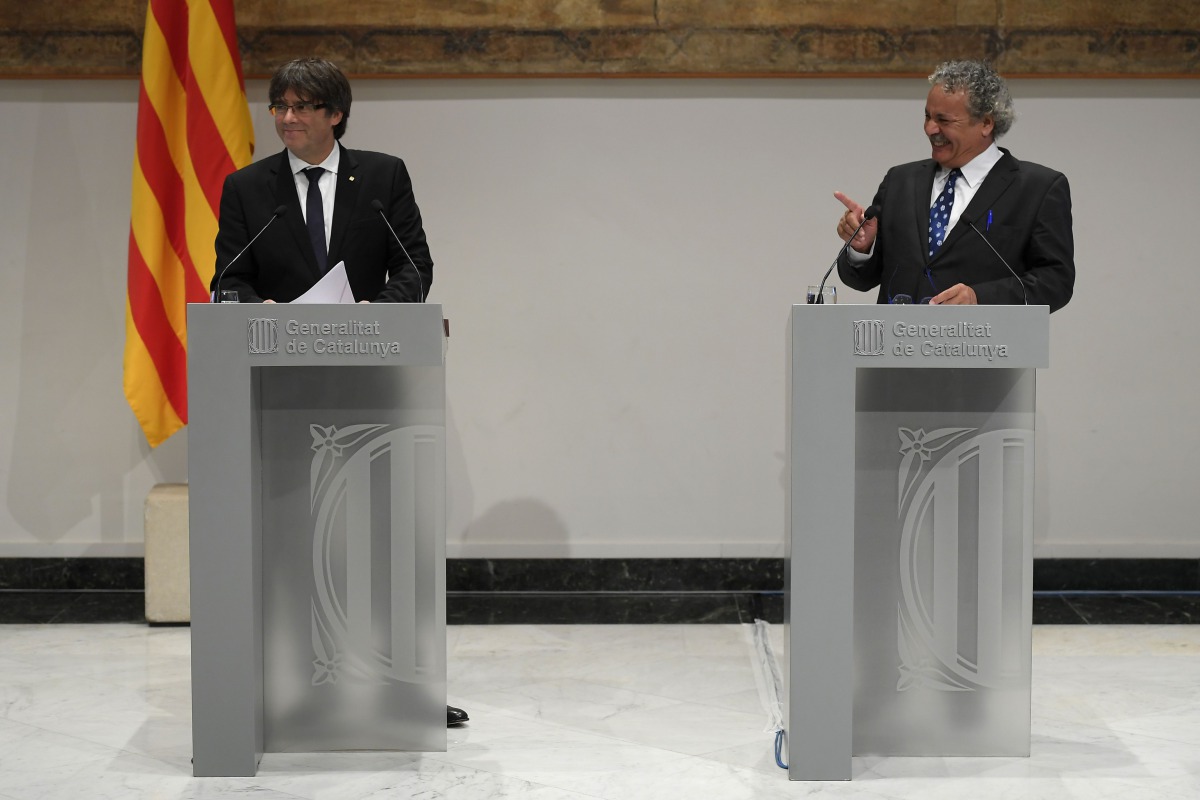 President of the Catalan regional government Carles Puigdemont (L) listens to Tunisian human rights activist Ahmed Galai during a statement to the press in Barcelona on September 4, 2017. AFP / Lluis Gene