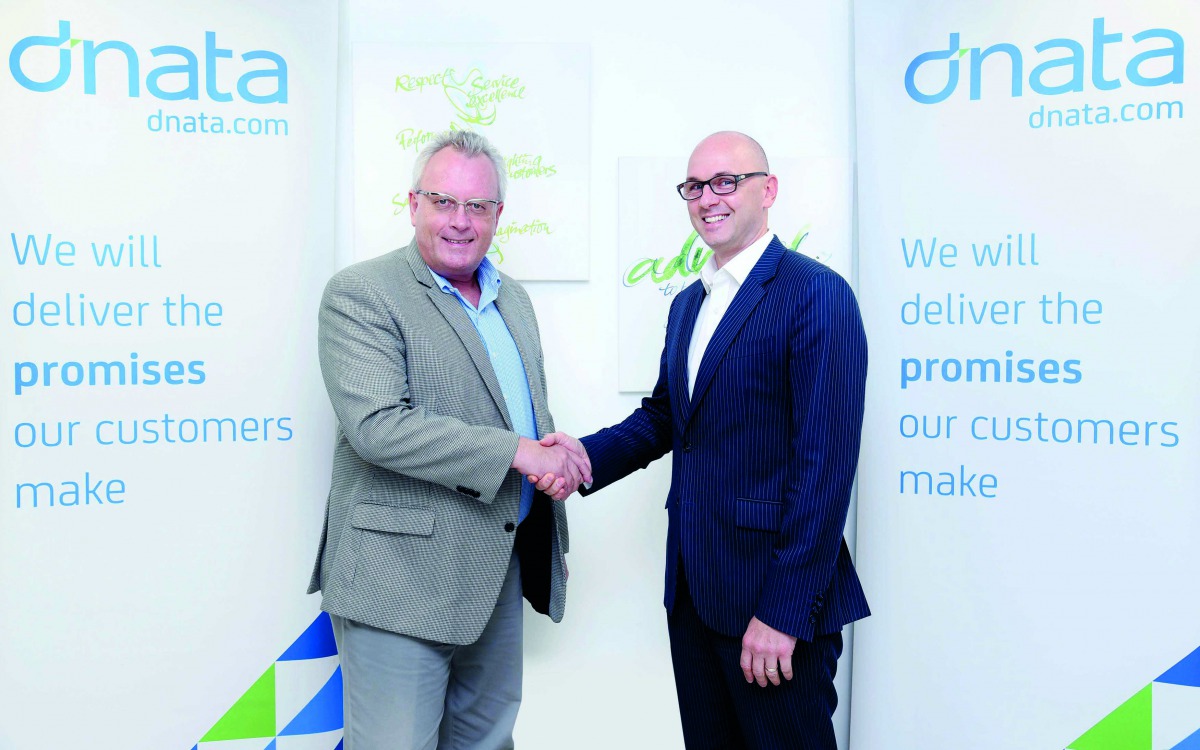 Senior officials of Siemens and dnata shaking hands.