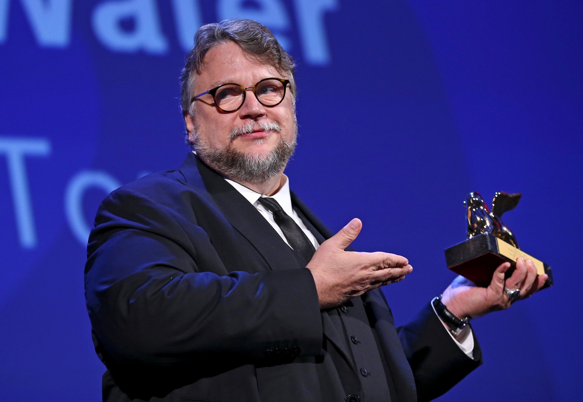 Director Guillermo Del Toro holds the Golden Lion award for the best movie 
