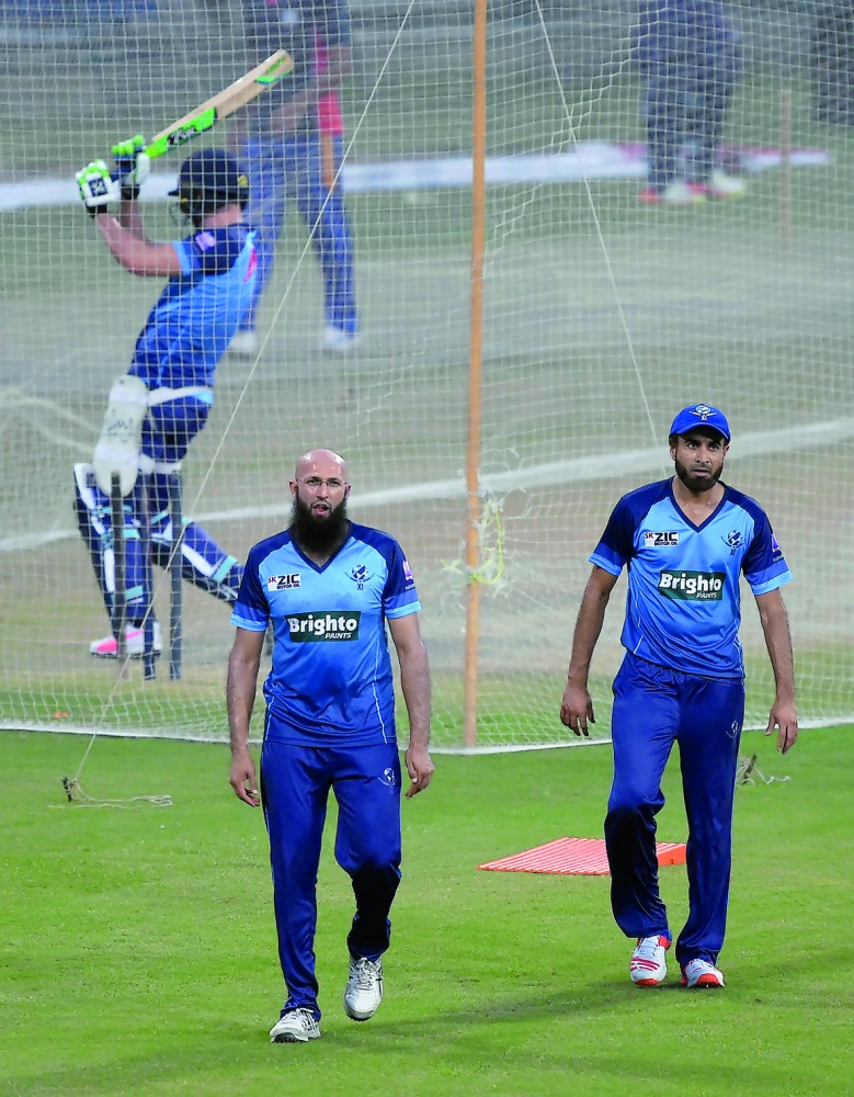 International World XI cricketers Hashim Amla (left) and Imran Tahir take part in a practice session at the Gaddafi Cricket Stadium in Lahore yesterday.