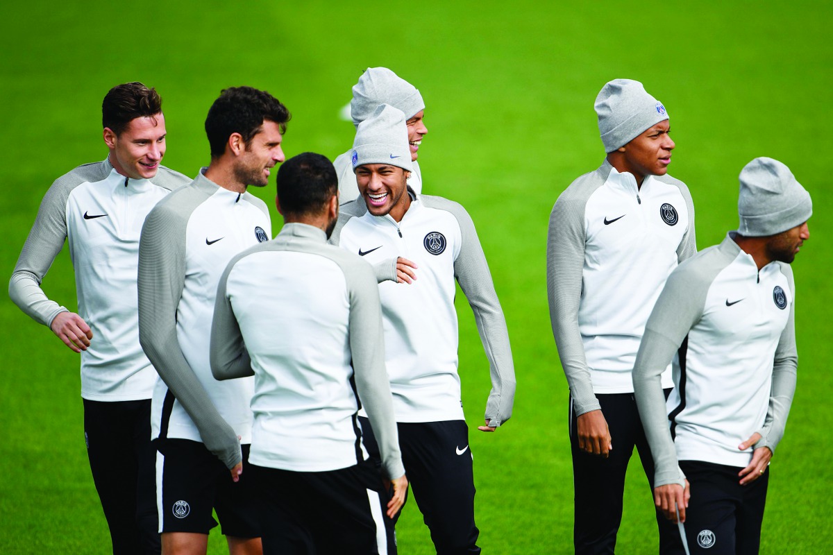 Paris Saint-Germain’s Brazilian forward Neymar (centre) laughs with team-mates during a training session at the Camp des Loges in Saint-Germain en Laye yesterday, on the eve of their Champions League match against Celtic FC.