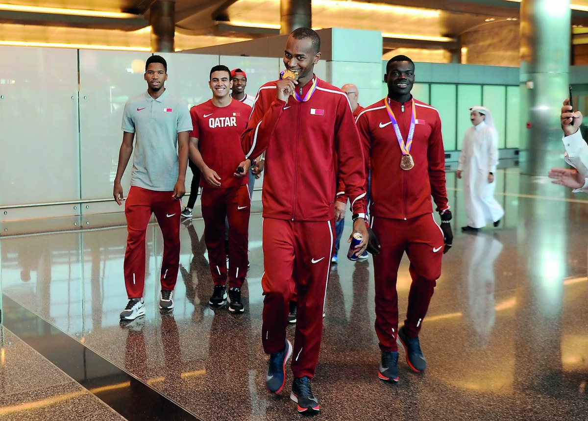 World high jump champion Mutaz Essa Barshim (second right), bronze medallist at the IAAF World Championships in London, Abderrahman Samba (right), Ashraf Elseify and Ahmed Bedeir arrive at the Hamad International Airport in Doha yesterday.  Picture: Abdul