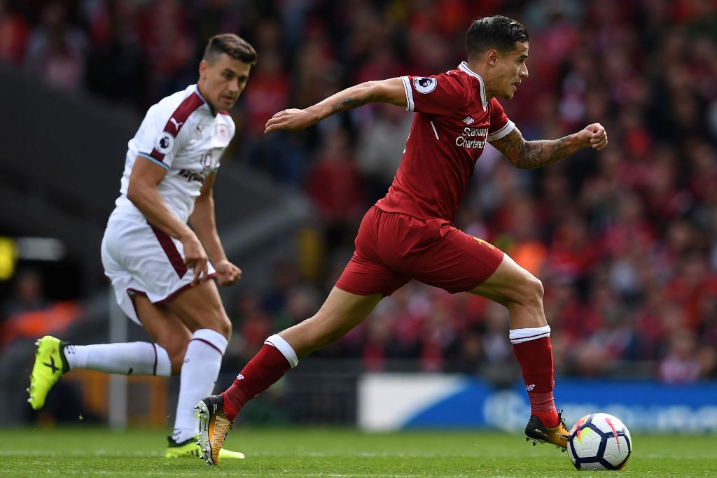 Liverpool's Brazilian midfielder Philippe Coutinho (R) runs away from Burnley's English defender Matthew Lowton during the English Premier League football match between Liverpool and Burnley at Anfield in Liverpool, north west England on September 16, 201
