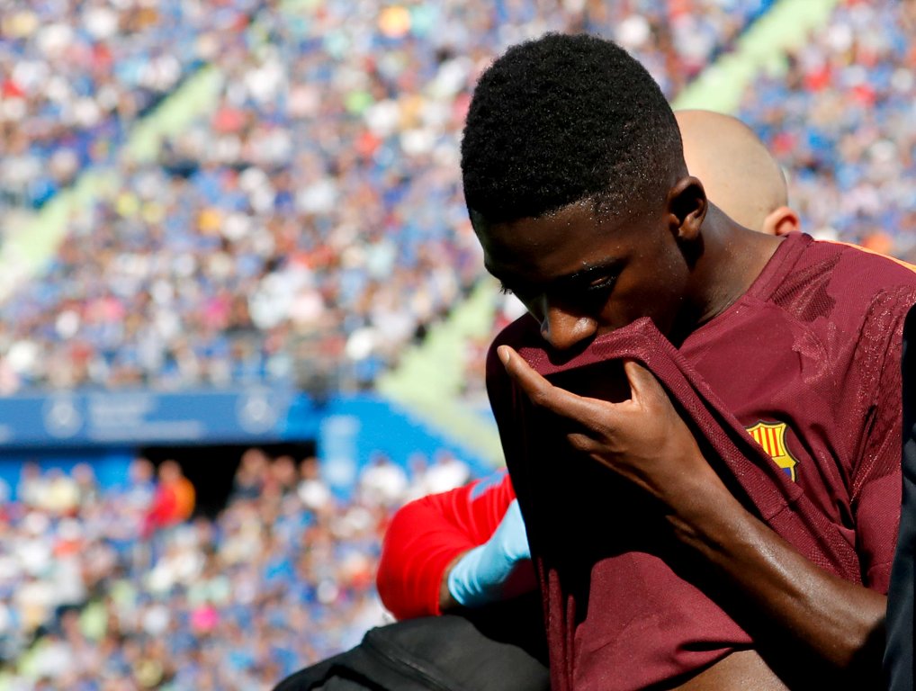 Barcelona's record signing Ousmane Dembele reacts as he leaves the pitch after sustaining an injured during his Spanish La Liga match against Getafe at Colisseum Alfonso Perez stadium in Getafe, Spain, September 16, 2017. Picture taken September 16, 2017.