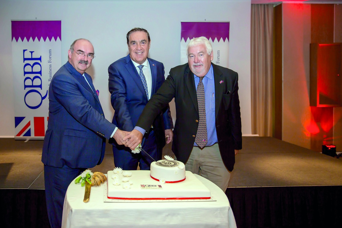 QBBF officials cutting a cake to celebrate the 25th anniversary of the forum.