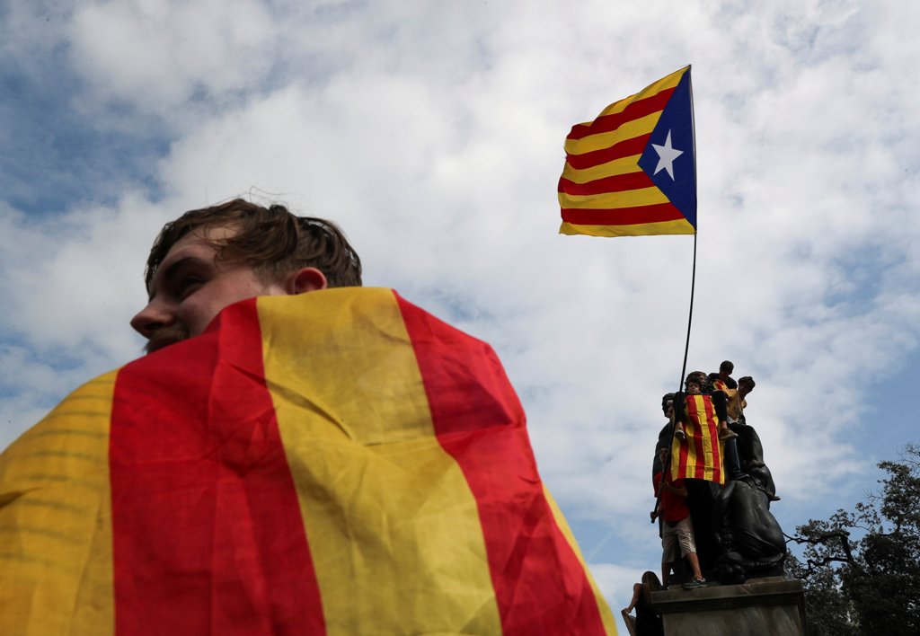 People wave an Estelada (Catalan separatist flag) during a protest one day after the banned independence referendum in Barcelona, Spain October 2, 2017. REUTERS/Susana Vera
