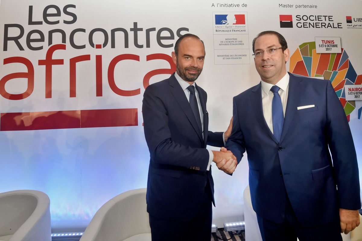 Tunisian Prime Minister Youssef Chahed (right) shakes hands with his French counterpart Edouard Philippe during a France-Africa economic meeting in Tunis, yesterday.
