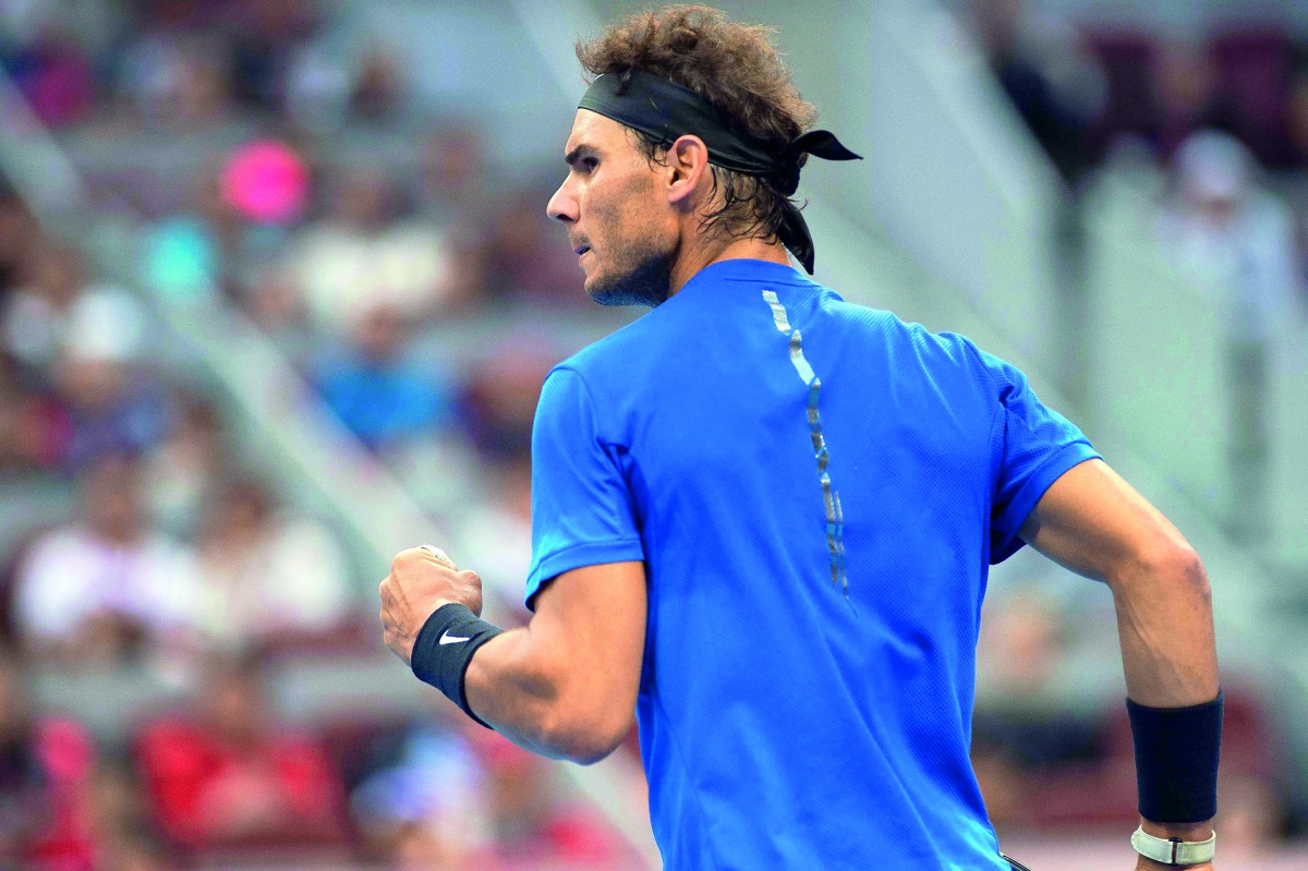 Alexander Zverev of Germany in action against Fabio Fognini of Italy in Beijing. RIGHT, BELOW: Rafael Nadal of Spain celebrates during his second-round match against Karen Khachanov of Russia.