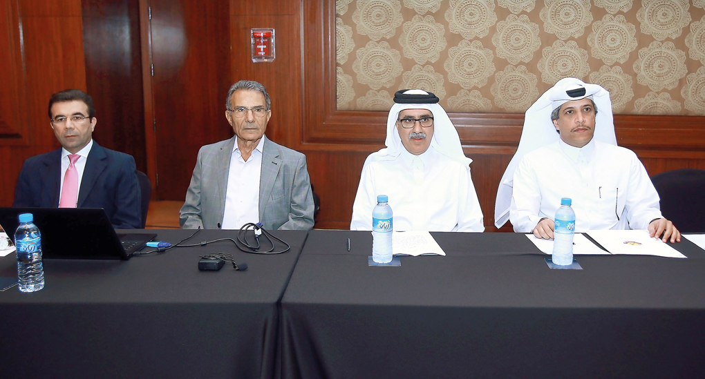 Ahmed Mohammed Al Shaabi (second right), Executive Director of the Common Services Sector at QCB, and Bahij Naji Al Khatib (second left), Director of the Training Department of the Union of Arab Banks, along with other officials, discussing the provisions