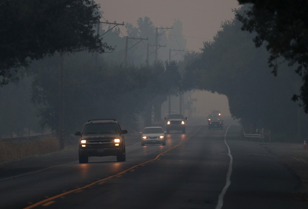 Cars drive through thick smoke along Route 29 on October 13, 2017 in Yountville, California. Justin Sullivan/AFP
