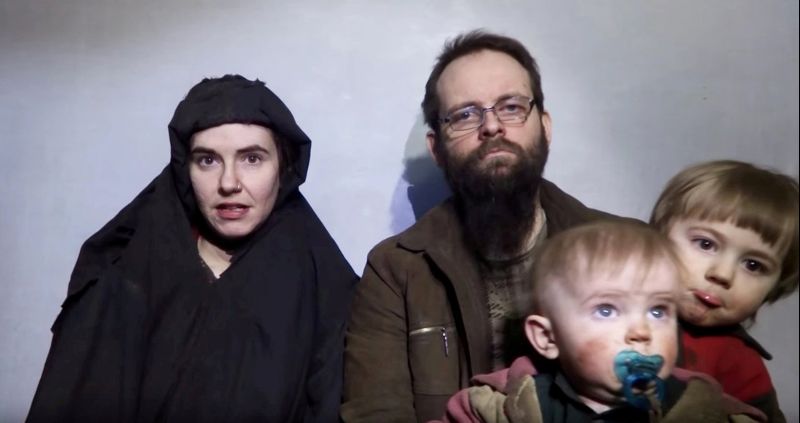 A still image from a video posted by the Taliban on social media on December 19, 2016 shows American Caitlan Coleman (L) speaking next to her Canadian husband Joshua Boyle and their two sons. Courtesy Taliban/Social media via REUTERS