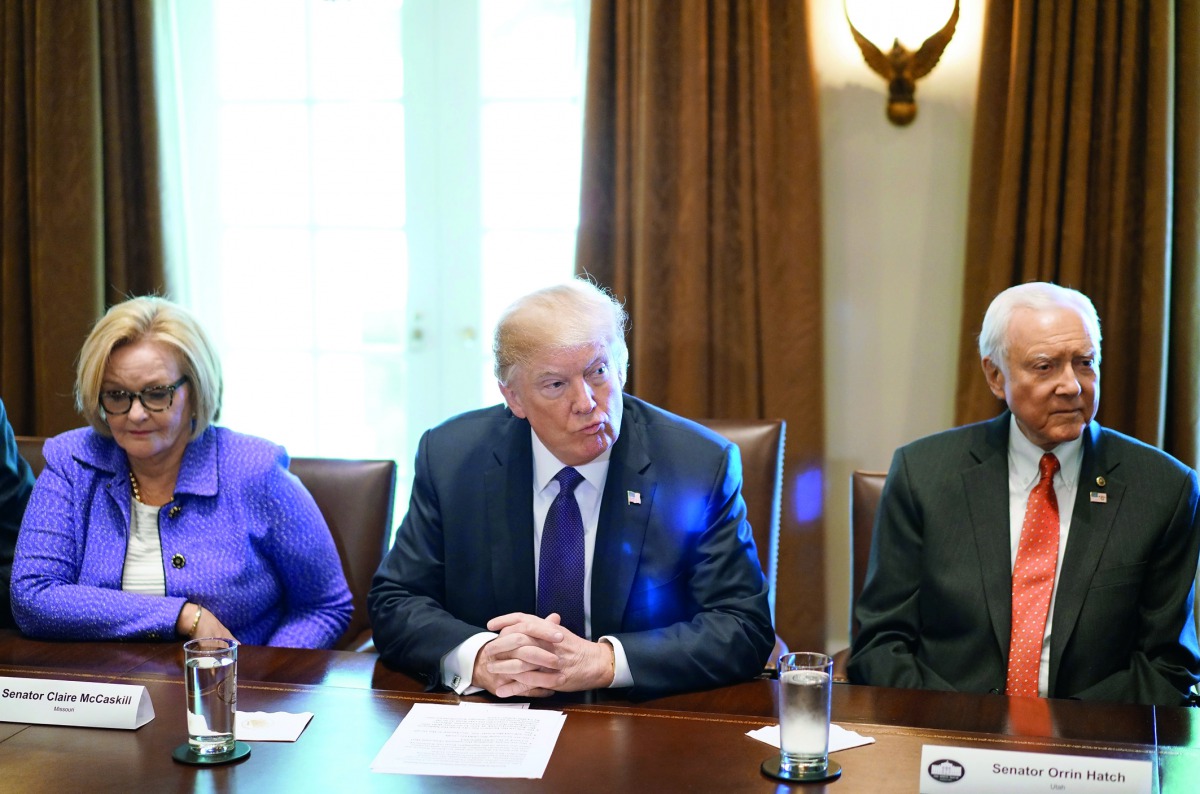 US President Donald Trump (centre), Senator Claire McCaskill (left) & Senate Finance Committee Chairman Orin Hatch take part in a meeting with members of the Senate Finance Committee and his economic team in the Cabinet Room at the White House in Washingt
