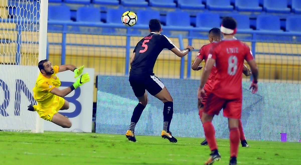Umm Salal goalkeeper Basel Zaidan blocks a goal bound shot from Al Duhail striker Youssef El Arabi during their QNB Stars League match at Al Gharafa Stadium yesterday. Al Duhail won 4-1.  Pictures: Kammutty VP/The Peninsula 