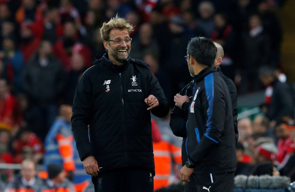 Liverpool manager Juergen Klopp and Huddersfield Town manager David Wagner share a joke during the match Action Images via Reuters/Craig Brough  
