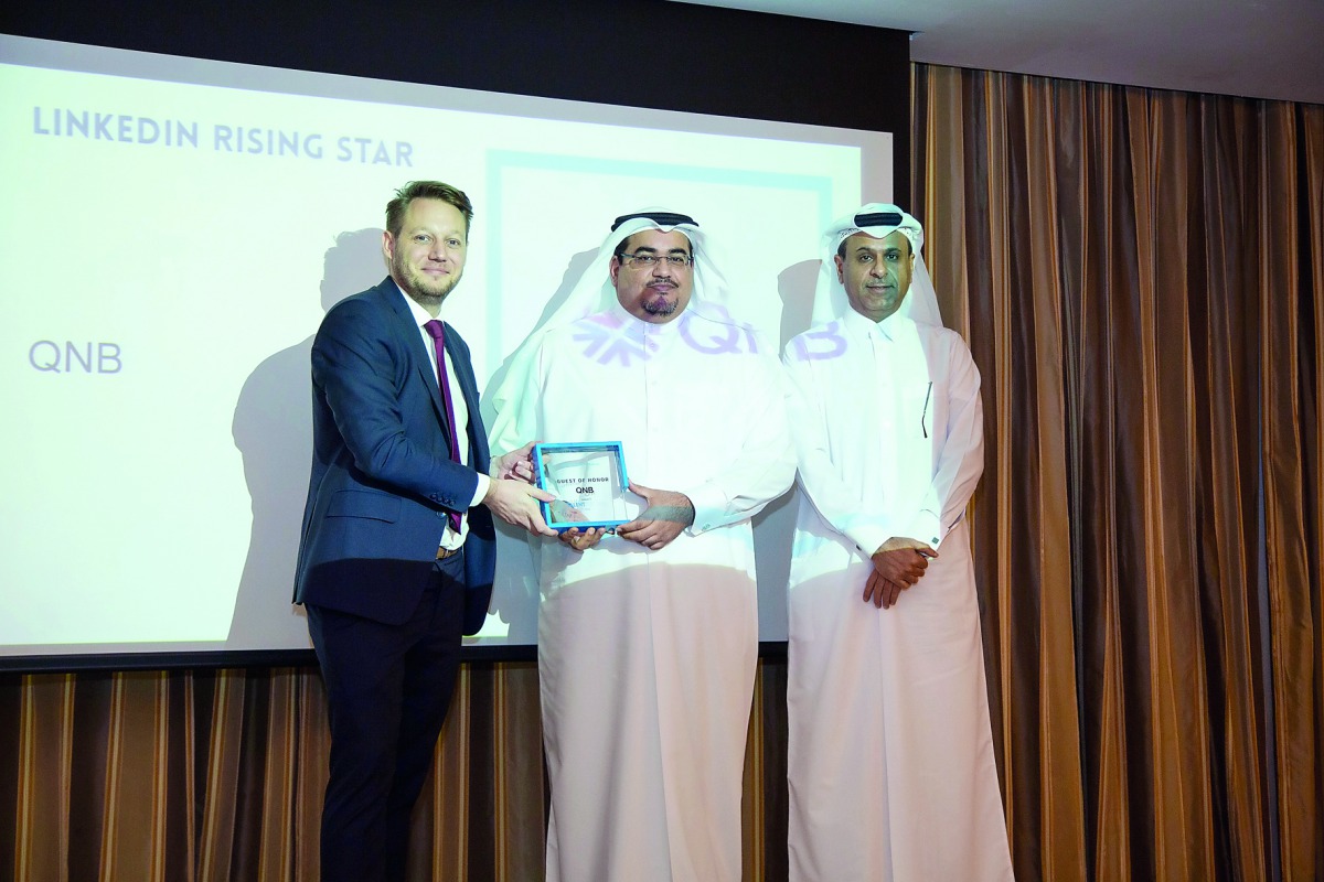 Yousef Ali Darwish (centre), General Manager-Group Communications, QNB, receiving the award at the event.