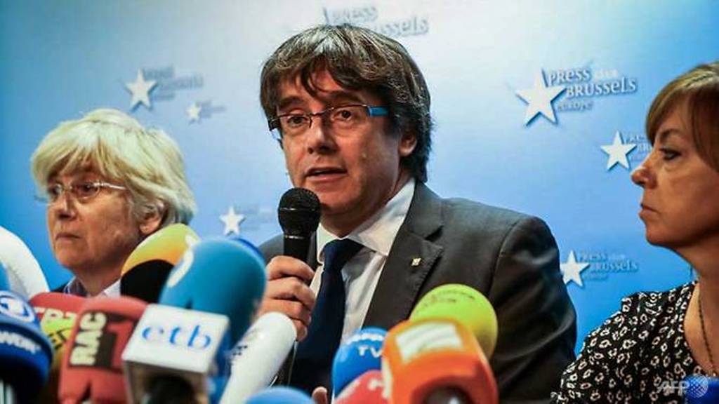 Catalonia's dismissed leader Carles Puigdemont (centre) along with other members of his dismissed government address a press conference at The Press Club in Brussels. (Aurore Belot/AFP).