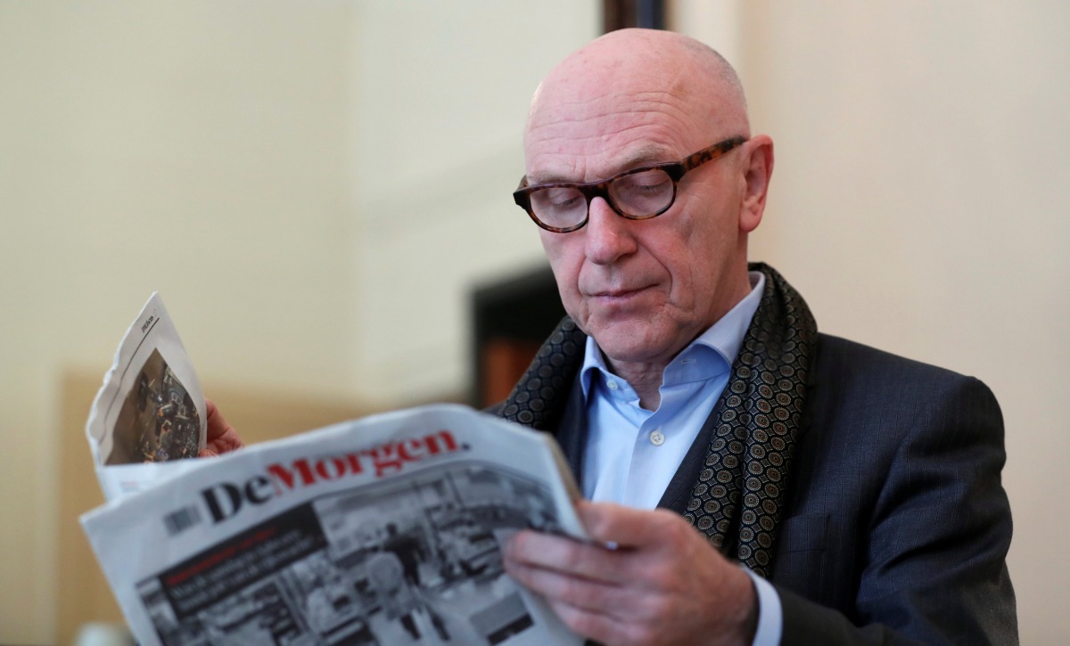 Sacked Catalan leader Carles Puigdemont's Belgian lawyer, Paul Bekaert, reads a newspaper in his office in Tielt in Belgium November 2, 2017. Reuters/Yves Herman