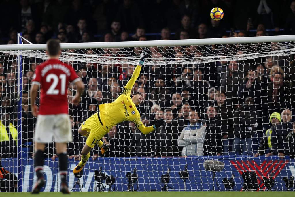 Chelsea's Belgian goalkeeper Thibaut Courtois watches a late freekick go over during the English Premier League football match between Chelsea and Manchester United at Stamford Bridge in London on November 5, 2017.  AFP / Adrian DENNIS