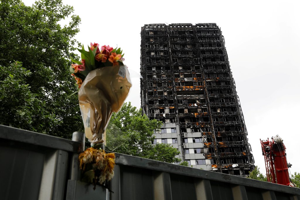 FILE PHOTO: A floral tribute is seen near the Grenfell Tower, which was destroyed in a fatal fire, in London, Britain July 15, 2017. REUTERS/Tolga Akmen/File Photo
