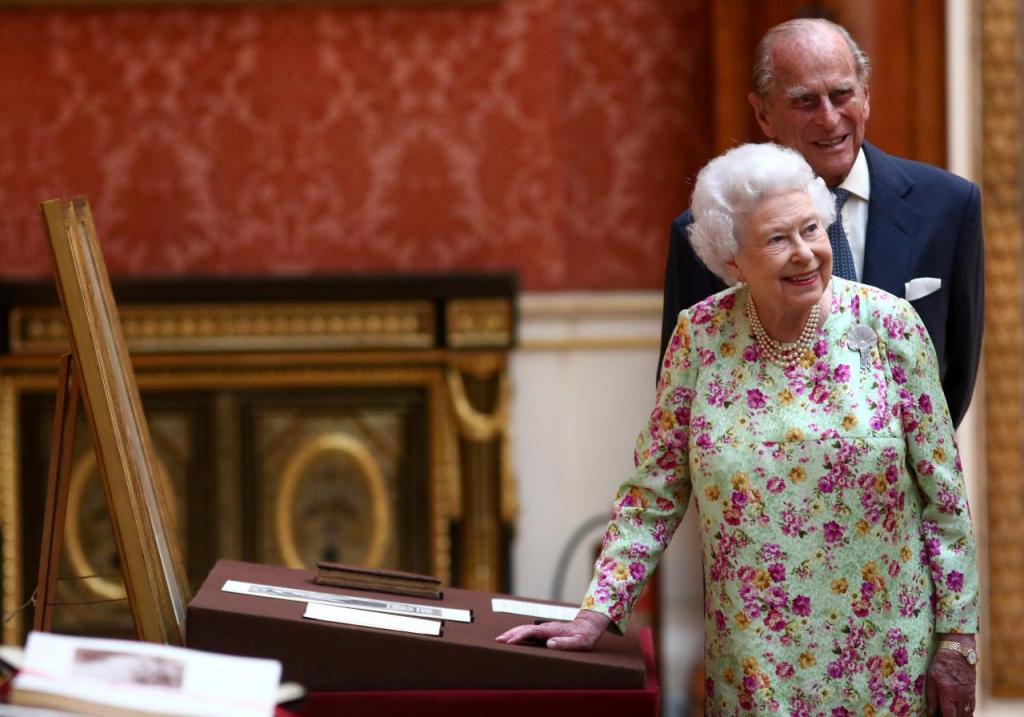 A file photo of Britain's Queen Elizabeth II and Prince Philip, Duke of Edinburgh stand next to a display of Spanish items from the Royal Collection at Buckingham Palace, London, Britain July 12, 2017. REUTERS/Neil Hall