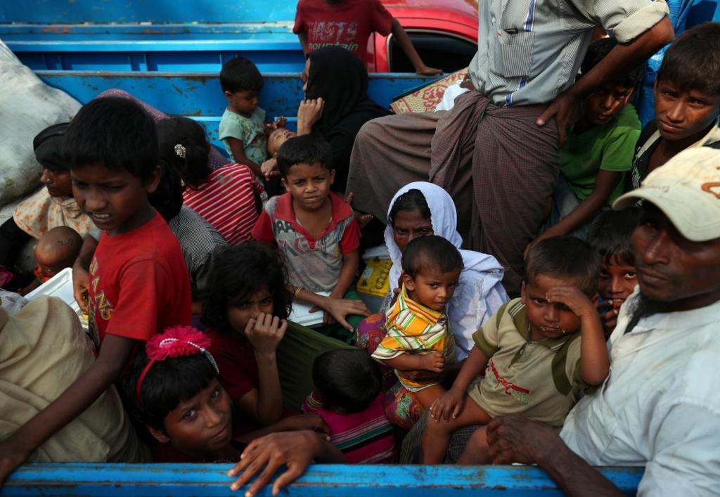 Rohingya refugees who arrived from Myanmar wait on a truck that will take them to a refugee camp from a relief centre in Teknaf, Bangladesh, October 25, 2017. REUTERS/Hannah McKay.