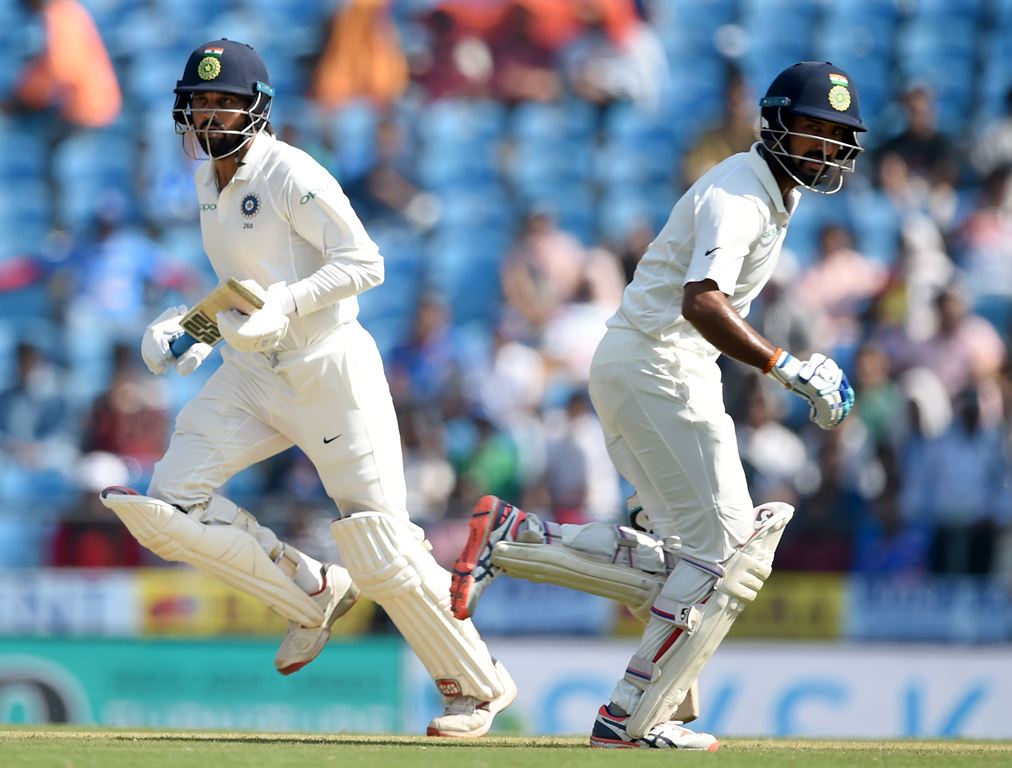 Indian cricketers Murali Vijay (L) and Cheteshwar Pujara run between the wickets during the second day of the second Test cricket match between India and Sri Lanka at the Vidarbha Cricket Association Stadium in Nagpur on November 25, 2017.  AFP / PUNIT PA