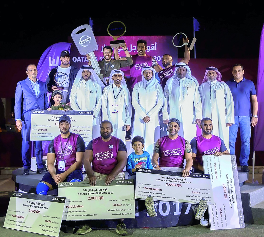 “Qatar’s Strongest Man” 2017 winner Abdulaziz Al Kuwari (second left, back row) with other participants and officials at the awarding ceremony which marked the conclusion of the event at Aspire Park last night.