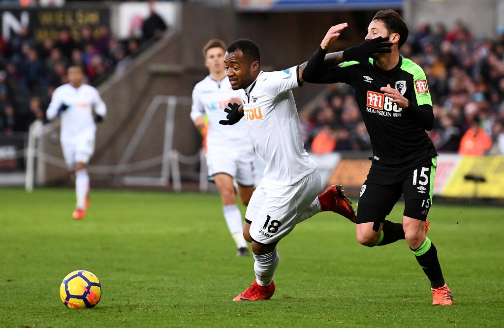 Swansea City's Jordan Ayew in action with Bournemouth's Adam Smith. REUTERS/Dylan Martinez 