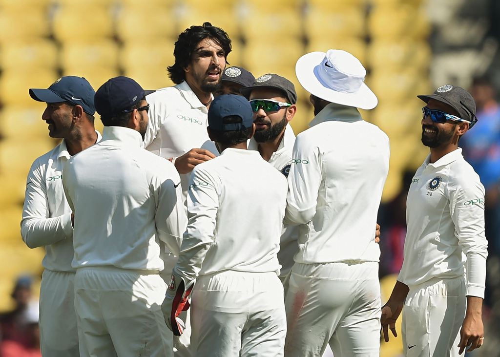 Indian cricketer Ishant Sharma (C) celebrates with teammates after taking the wicket of Sri Lanka batsman Niroshan Dickwella during the fourth day of the second Test cricket match between India and Sri Lanka at the Vidarbha Cricket Association Stadium in 