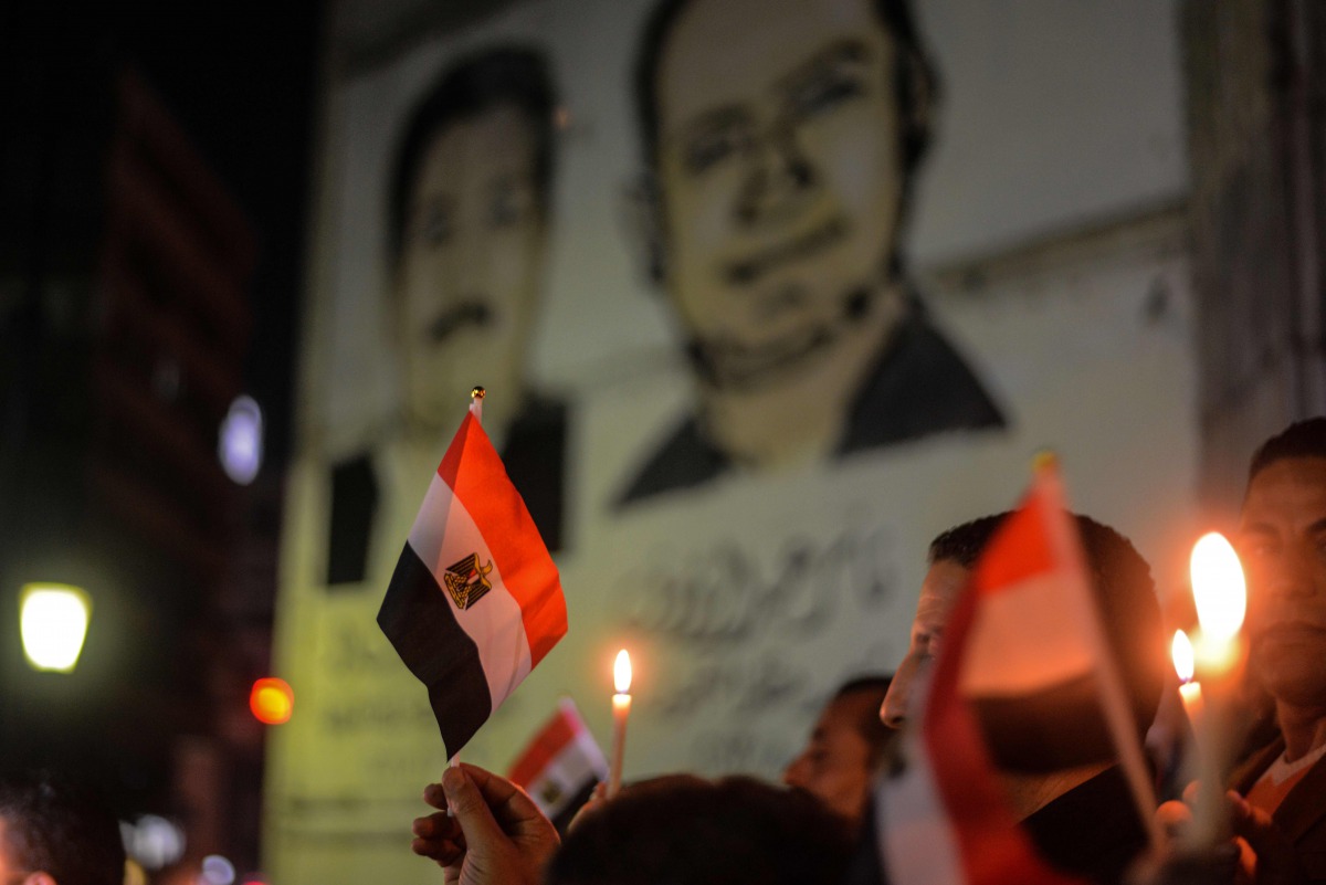 Egyptians hold candles at a vigil outside the Syndicate of Journalists in the capital Cairo's downtown district on November 27, 2017, in the memory of the victims of a bomb and gun assault that left over 300 worshippers killed in the restive province of N