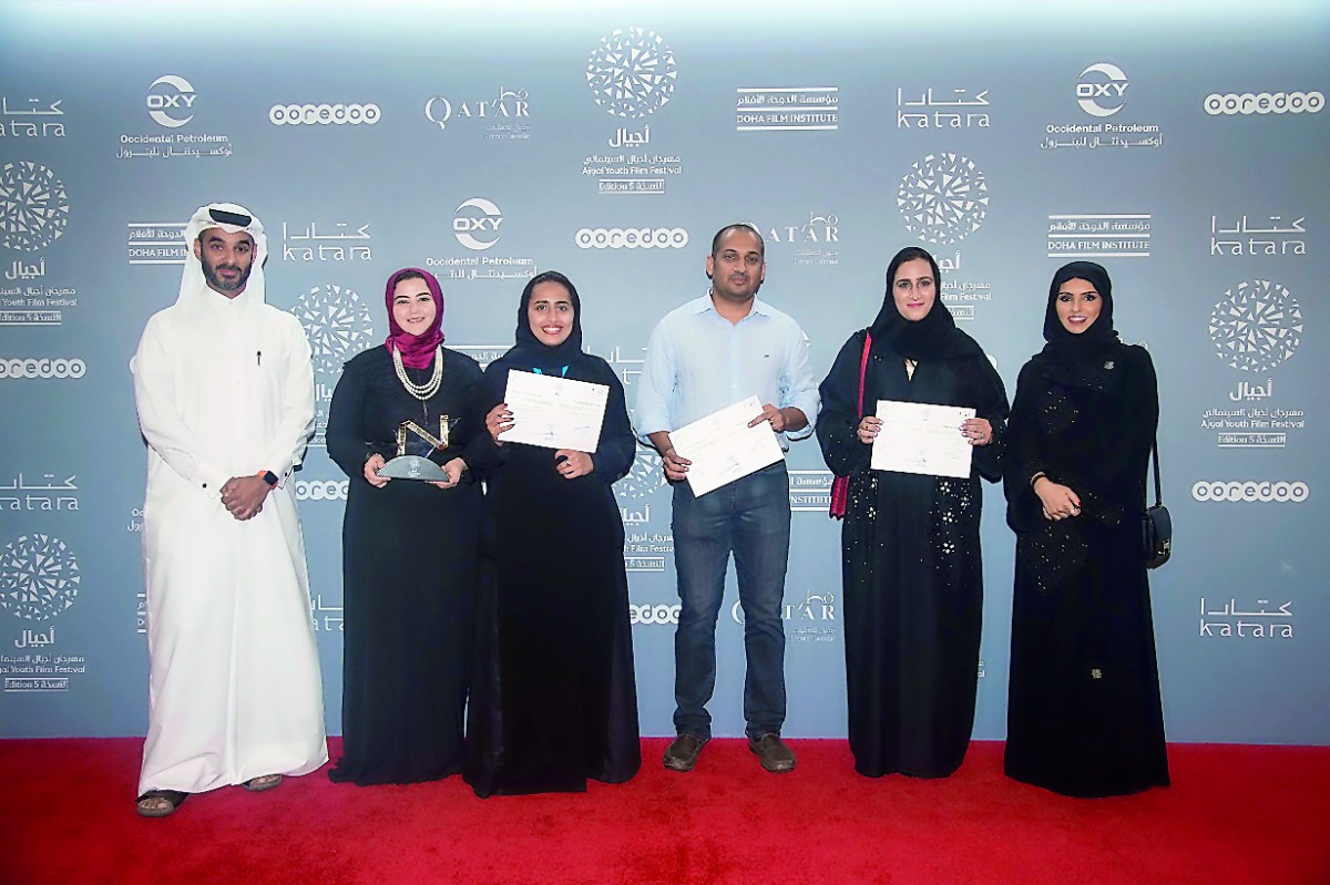 Chief Administrative Officer of Doha Film Institute, Abdulla Jassim Al Mosallam (left), CEO of Doha Film Institute, Fatma Al Remaihi (right), pose with award winners Nada Bedair, Rawda Al Thani, Nibu Vasudevan and Amal Al Muftah after the ‘Made in Qatar’ 