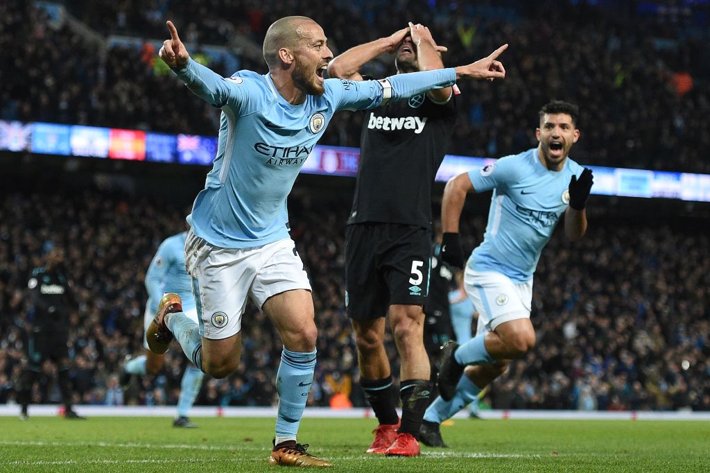 West Ham United's Argentinian defender Pablo Zabaleta (C) reacts as Manchester City's Spanish midfielder David Silva (L) celebrates scoring their second goal during the English Premier League football match between Manchester City and West Ham United at t