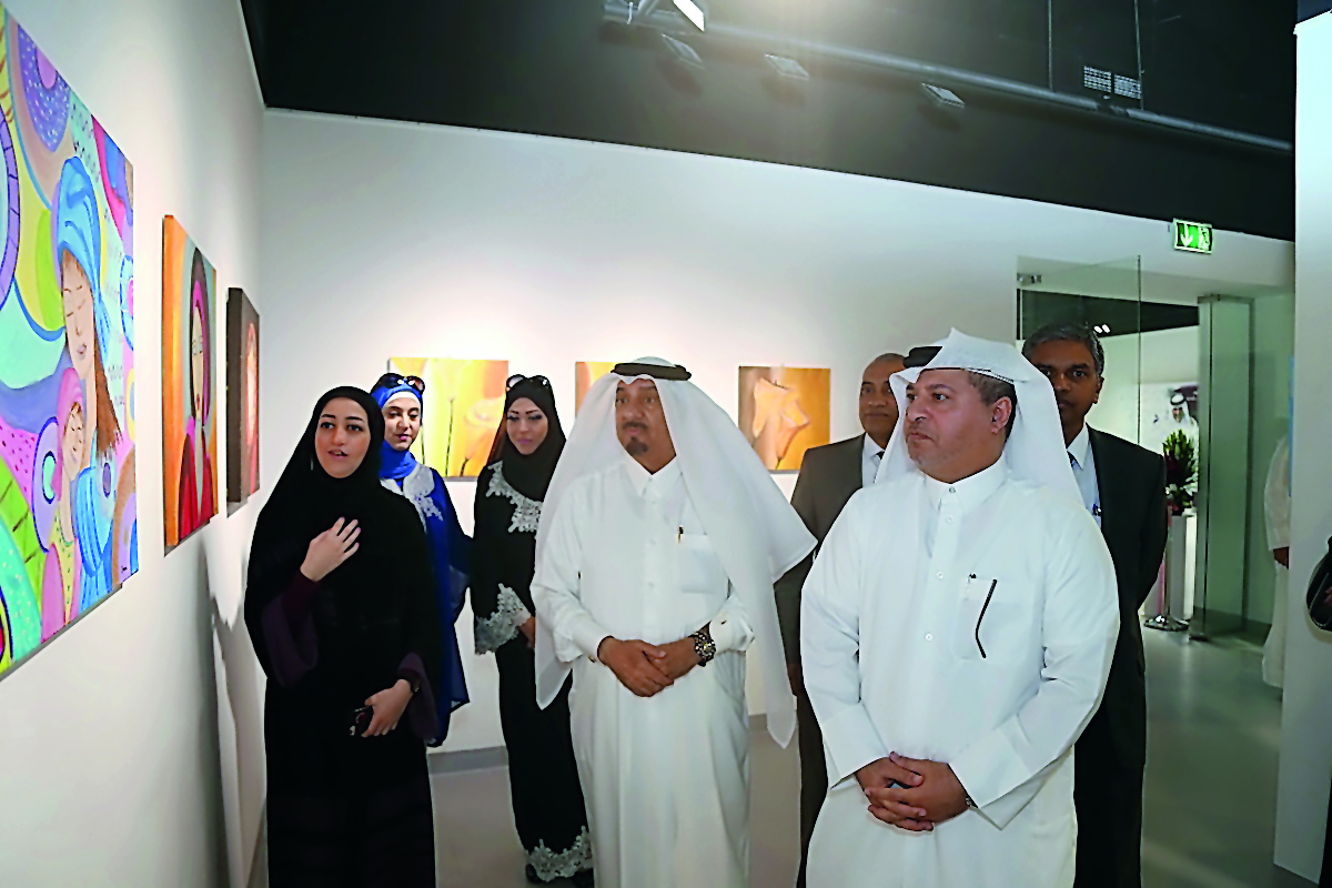 Ahmed Al Sayed, Deputy Director General of Operations at Katara, Dr. Mohamed Abdel Rahman Al Sayed, international representative of disability and other officials visiting paintings by artist Dania Tariq at the Cultural Village Foundation-Katara Building 