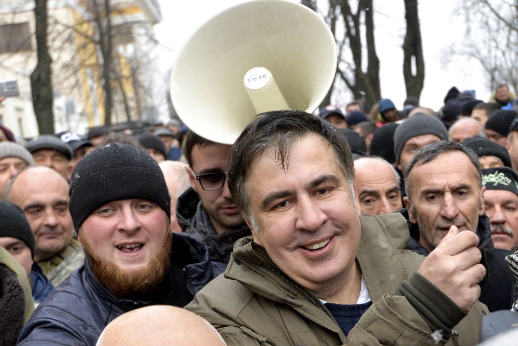 Former Georgian Mikheil Saakashvili (C-R) smiles after he was released by his supporters in downtown Kiev on December 5, 2017.   AFP / Sergei CHUZAVKOV
