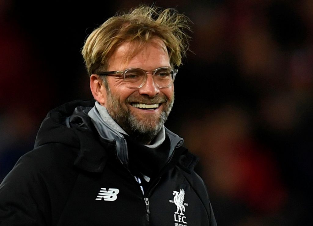 Liverpool's German manager Jurgen Klopp smiles on the pitch at the end of the UEFA Champions League Group E football match between Liverpool and Spartak Moscow at Anfield in Liverpool, north-west England on December 6, 2017. / AFP / Paul ELLIS
