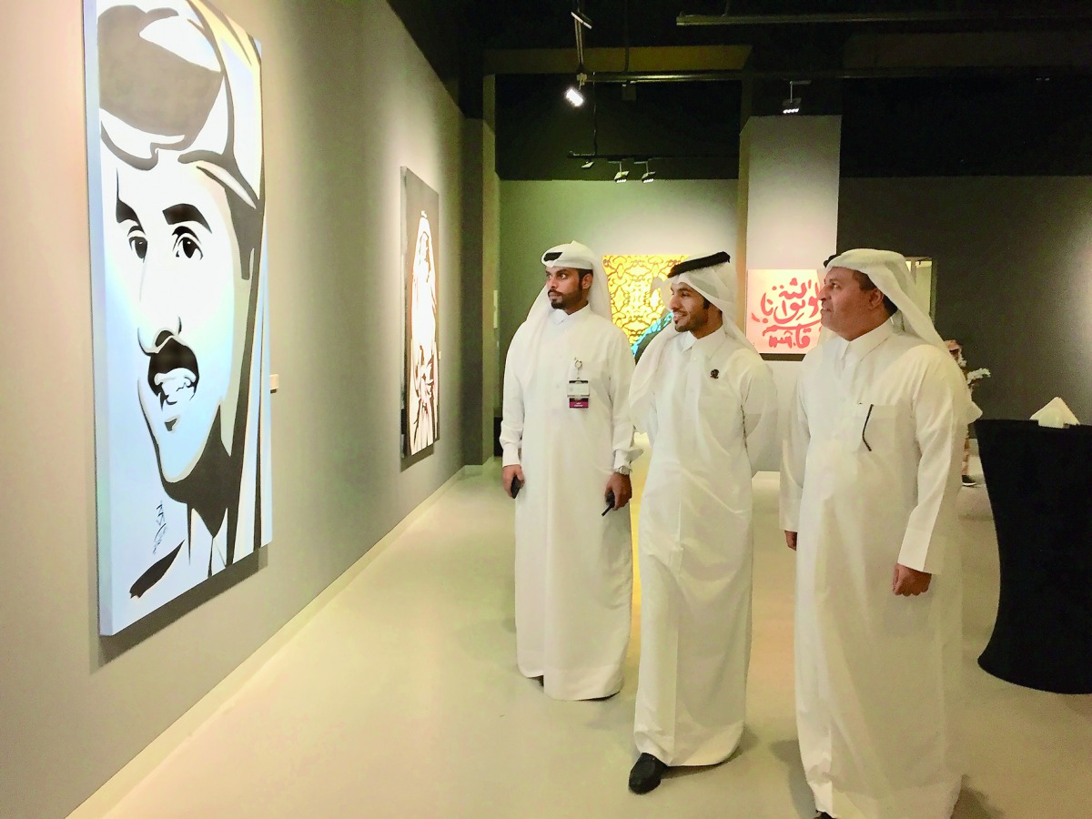 Qatari artist Ahmed Al Maadheed (centre) and Katara Deputy General Manager and Head of Operations Ahmad Al Sayed (right) tour the exhibition at Katara Building 18 yesterday. Pic: Raynald C Rivera / The Peninsula