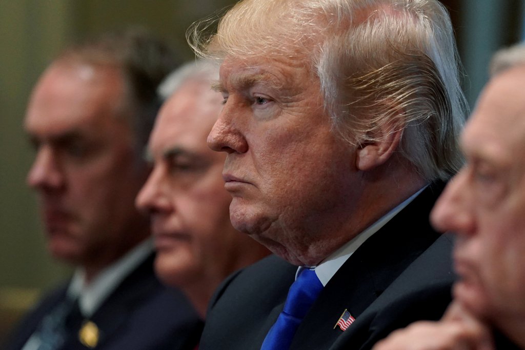 U.S. President Donald Trump, flanked by Interior Secretary Ryan Zinke, Secretary of State Rex Tillerson, and Defense Secretary James Mattis, holds a cabinet meeting at the White House in Washington, U.S., December 20, 2017. REUTERS/Jonathan Ernst.