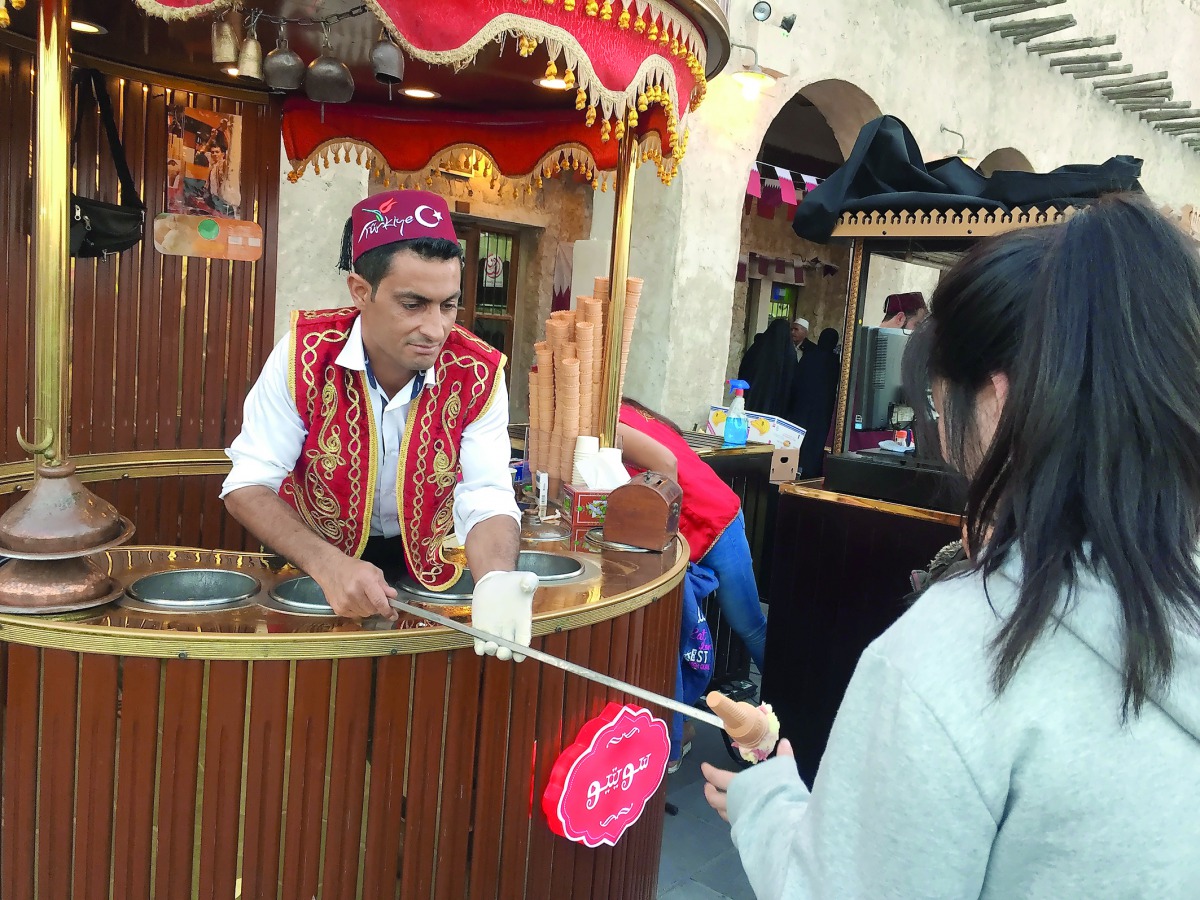 A vendor serves Turkish ice cream at one of the most popular food carts in Souq Waqif, yesterday. Pic: Raynald C Rivera / The Peninsula