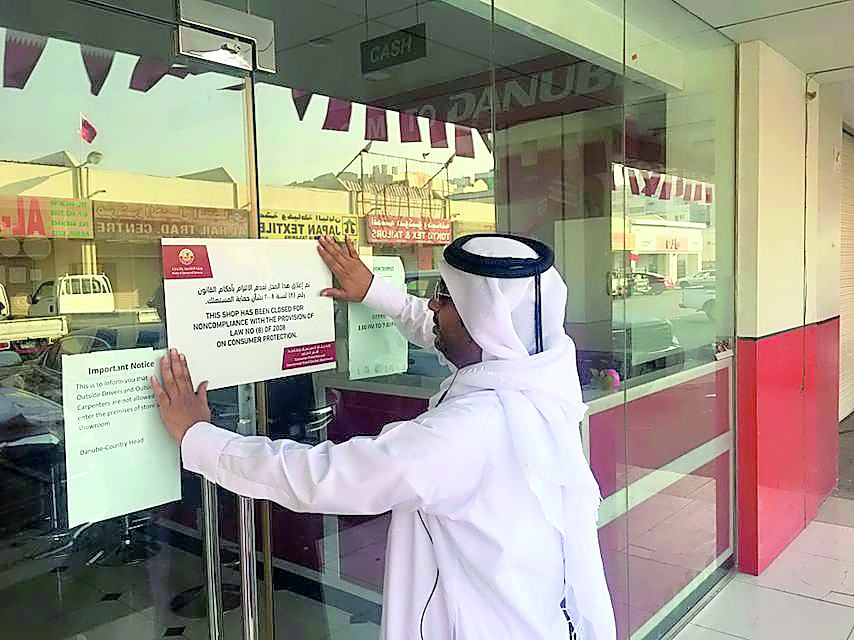 A Ministry official affixing the closure notice.