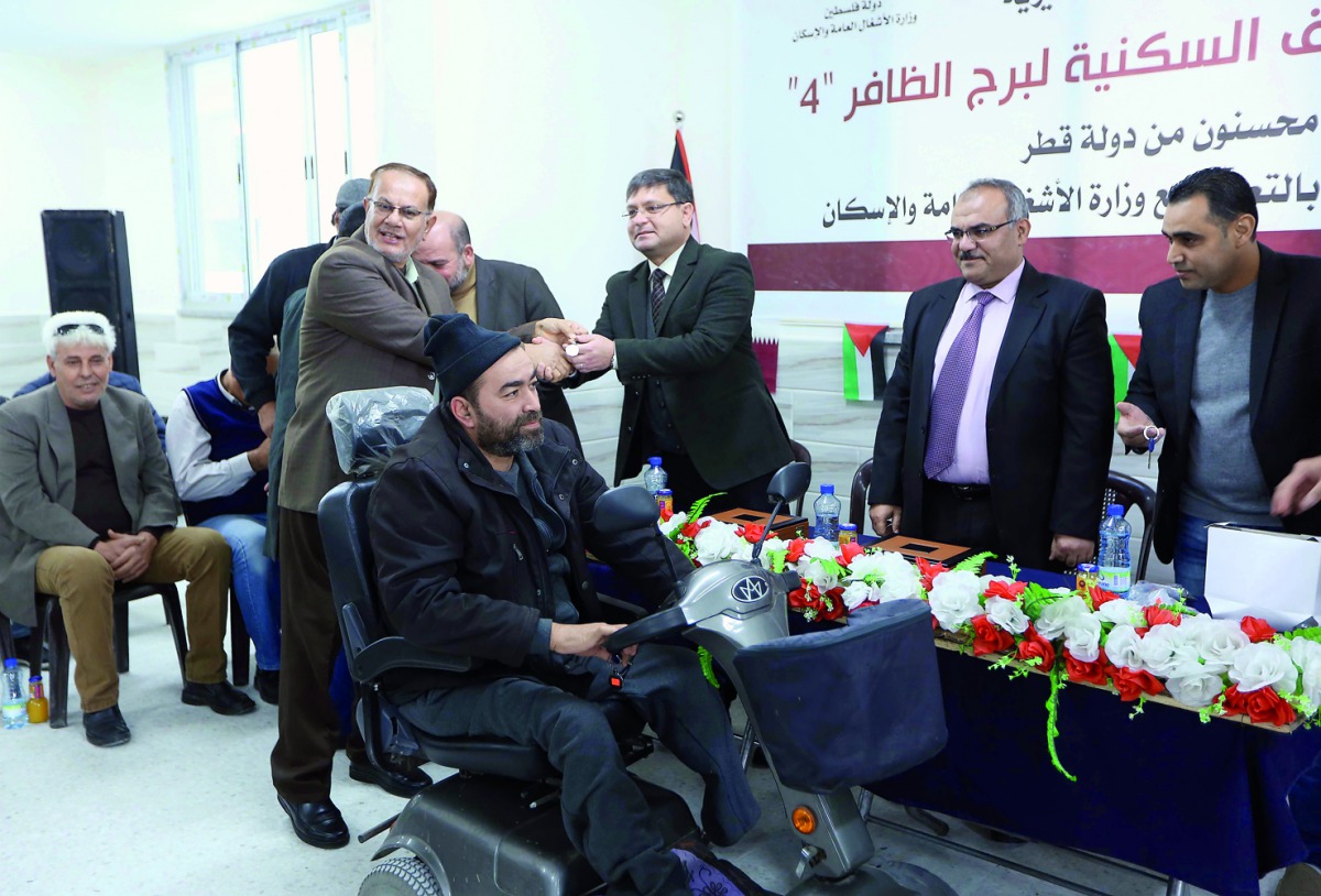 Palestinian families receiving keys of their newly reconstructed apartments in Al Dafer Tower in Gaza Strip. 