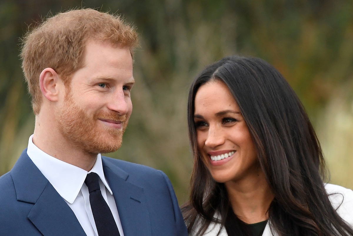 Britain's Prince Harry poses with Meghan Markle in the Sunken Garden of Kensington Palace in London, Britain, November 27, 2017. Reuters/Toby Melville