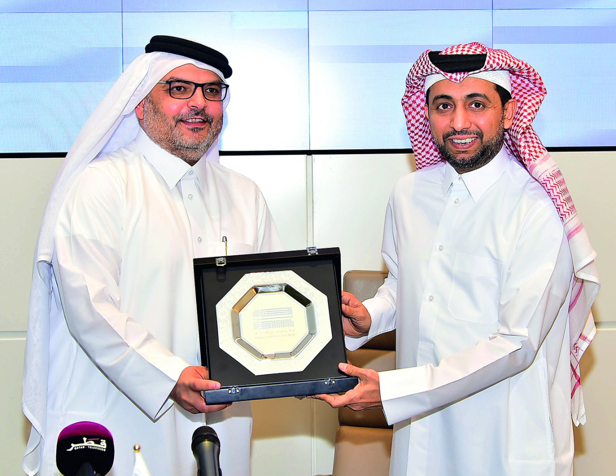 QU President Dr Hassan Al Derham (right) receiving a commemorative plaque from  Ashghal President Dr Eng Saad bin Ahmad Al Muhannadi.