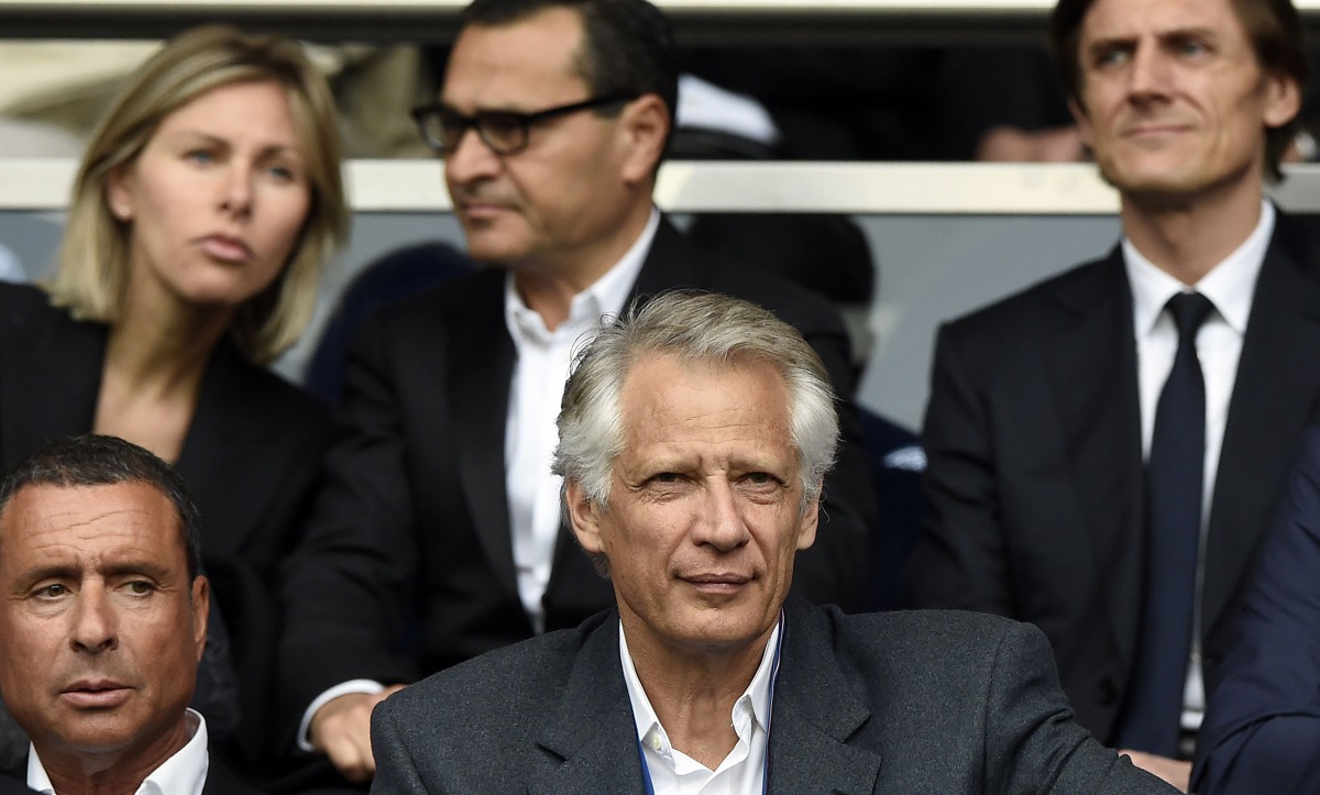 This file photo taken on April 23, 2014 shows France's former Prime Minister Dominique de Villepin (C) and businessman Alexandre Djouhri (L) attending the French L1 football match between Paris Saint-Germain (PSG) and Evian-Thonon (ETG) at the Parc des Pr