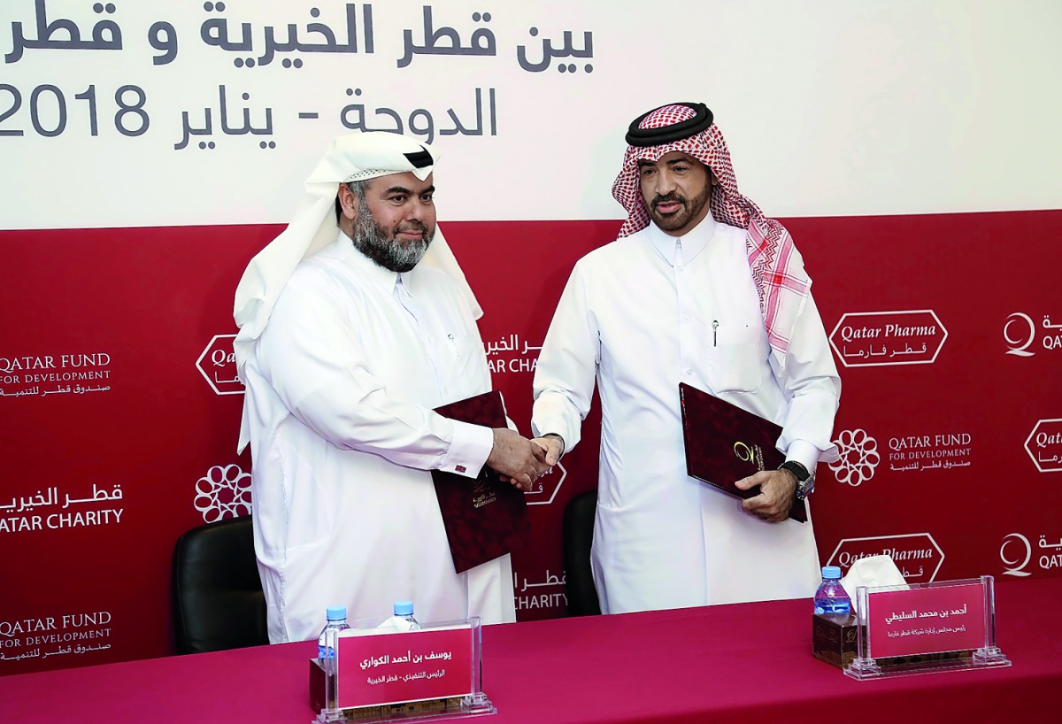 Qatar Charity CEO, Yousef bin Ahmed Al Kuwari, and Qatar Pharma Chairperson, Dr. Ahmed bin Mohammed Al Sulaiti, at the agreement signing event.