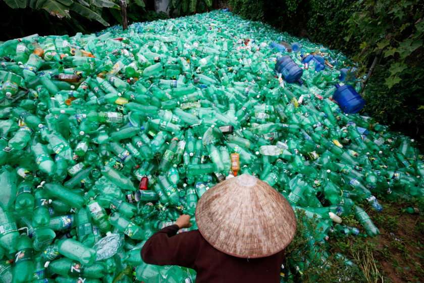 A woman sorts out recyclable plastic soft drink bottles at Xa Cau Village, outside Hanoi, Vietnam. Reuters/Kham