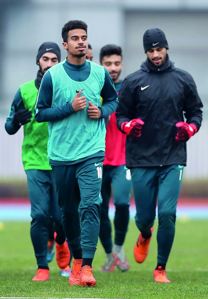 Qatari star Akram Afif (foreground) and team-mates train ahead of quarter-final clash against Palestine yesterday.