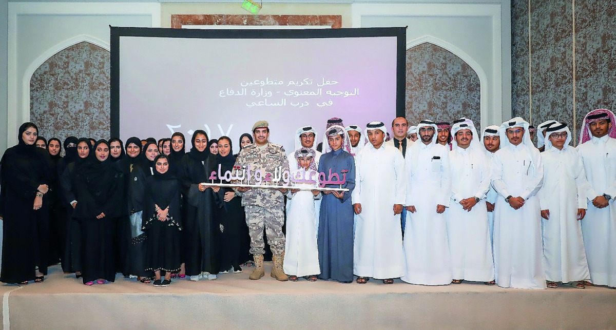 Officials with volunteers during the honouring ceremony.