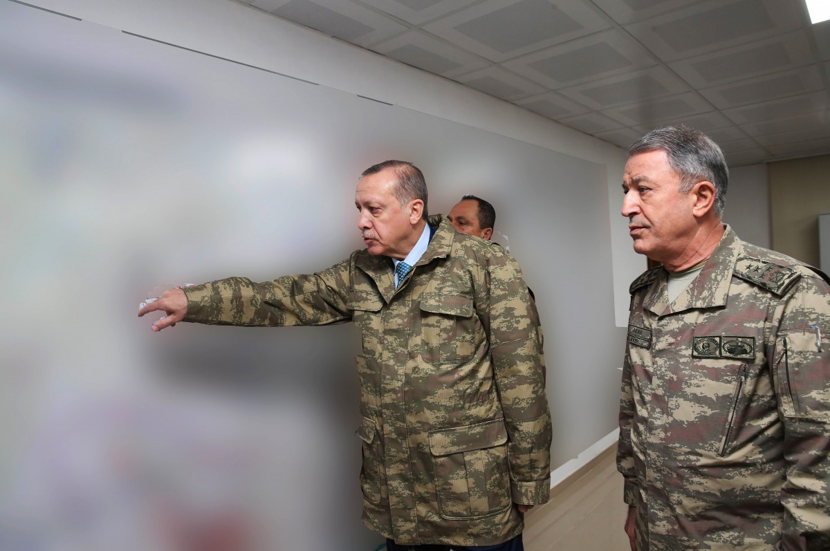  Turkey's President Recep Tayyip Erdogan (L), accompanied by Chief of the General Staff of the Turkish Armed Forces Hulusi Akar, gesturing during a briefing at the Operating Base in Hatay, on the sixth day of 'Operation Olive Branch.' AFP Photo / Turkish 