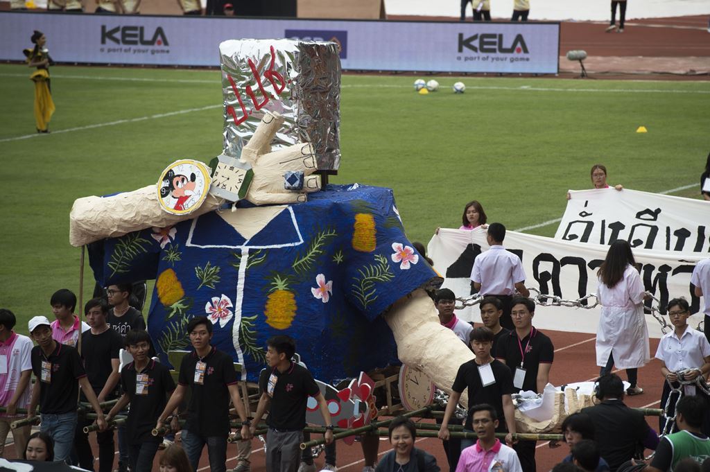 University students carry a parade float mocking Thailand's junta number two Prawit Wongsuwan over a current scandal over his undeclared collection of luxury watches, during the annual football match between Thammasat University and Chulalongkorn Universi
