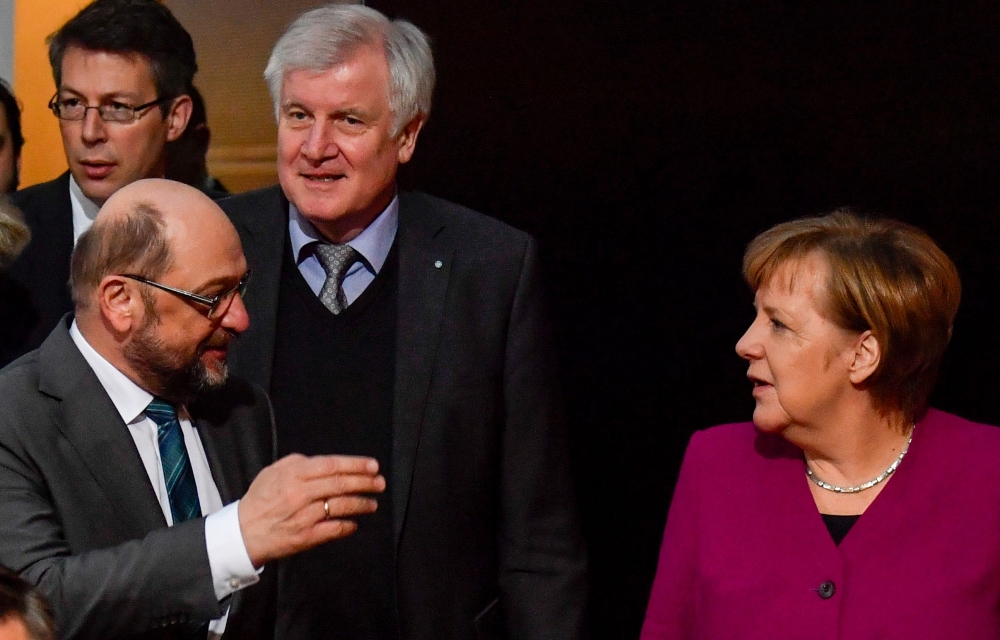 (FILES) This file photo taken on February 02, 2018 in Berlin shows German Chancellor and leader of the Christian Democratic Union (CDU) Angela merkel (R), the leader of the Social Democratic Party (SPD) Martin Schulz (L) and the chairman of the Bavarian C